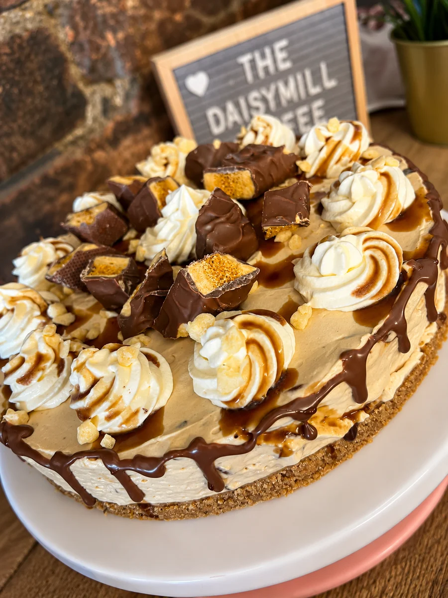 Decorated cream cake with chocolate pieces and drizzle