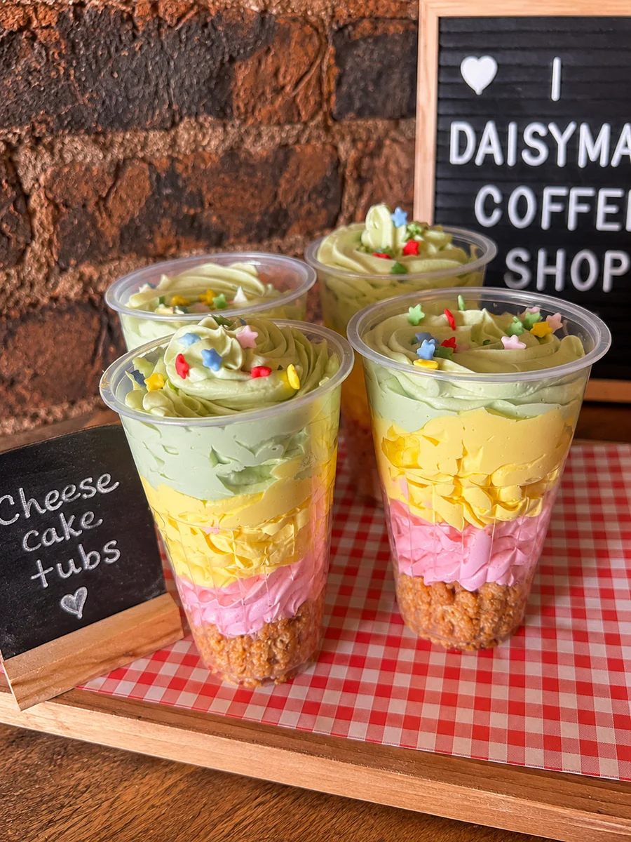 Layered cake tubs topped with colourful sprinkles