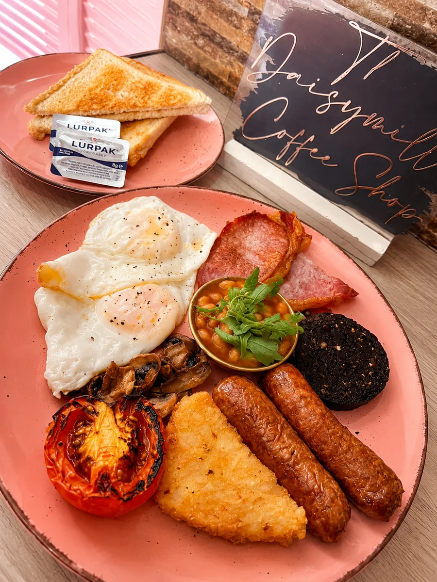 Cooked breakfast with eggs, sausage, bacon, black pudding and hash brown