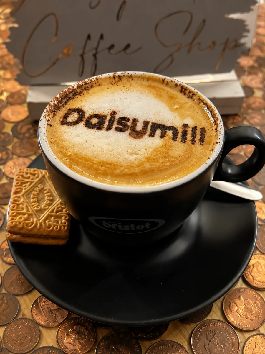 Coffee with The Daisymill name on the foam